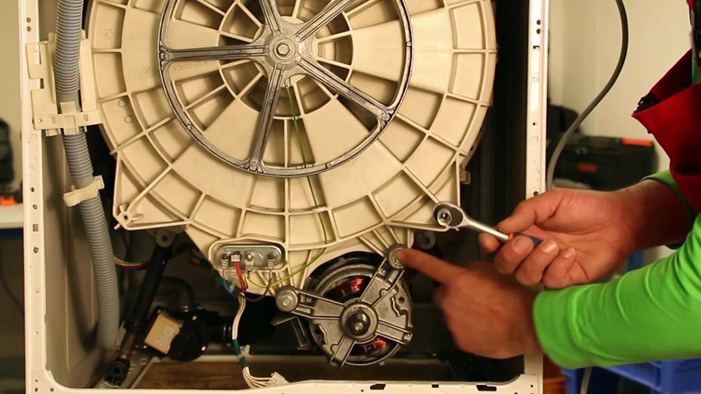 Repérez les boulons qui maintiennent le moteur du lave-linge frontal