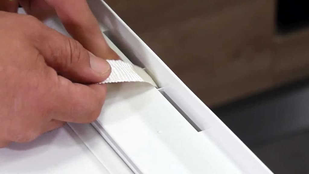 Passer la sangle par l'un des orifices du plateau